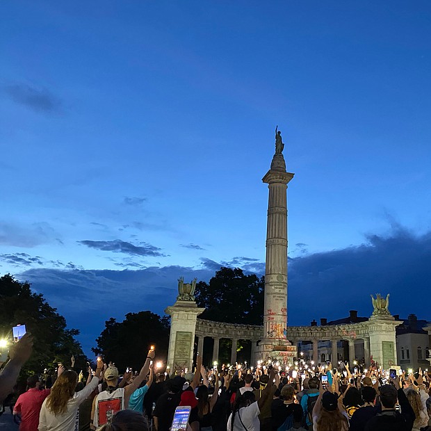 Hundreds gather for a Juneteenth candlelight vigil in front of the former monument to Confederate President Jefferson Davis, whose statue already has been torn down. The display capped the all-day celebration of the liberation of slaves on Friday, June 19. R&B singer Trey Songz was among the participants in the candlelight event that began at the Lee statue and culminated at the Davis monument.