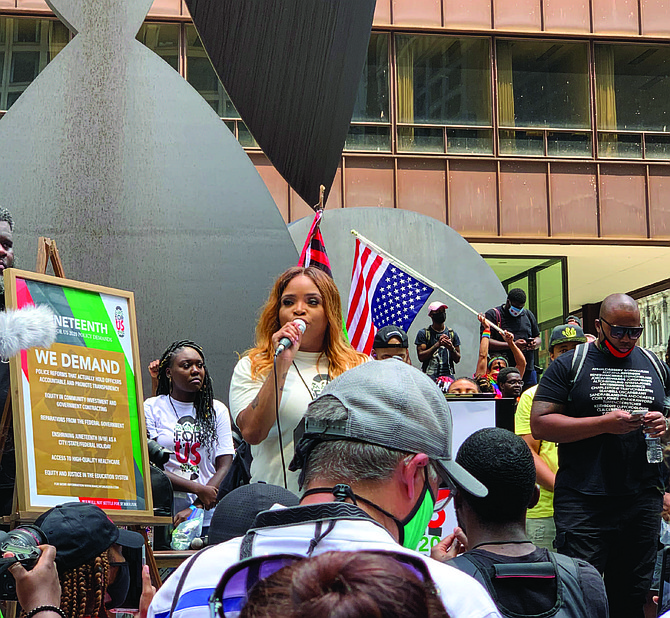 Ashley Munson, lead organizer of March for Us 2020, cited a list of demands during the Juneteenth March press conference at Daley Plaza. Munson said the goal is to create a more collaborative Black Chicago. Photo credit: By Tia Carol Jones