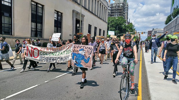 Protesters chant as they march down Broad Street in Downtown toward the state Capitol following a rally Wednesday outside the John Marshall Courts Building.