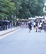 Marchers with Stonewall Rising stop in front of the Richmond Police Training Academy on West Graham Road, where they were met by a line of Richmond Police and State Police in riot gear. The face-off ended peacefully after several demonstrators spoke.