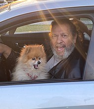 Former Richmond City Councilman Henry W. “Chuck” Richardson and his Pomeranian drive by the Lee statue on June 24, where people were peacefully gathered in a spirit of solidarity early in the day. Mr. Richardson, carrying out a protest of his own, said he will not cut the beard he has been growing during the pandemic until the Confederate monuments are taken down.