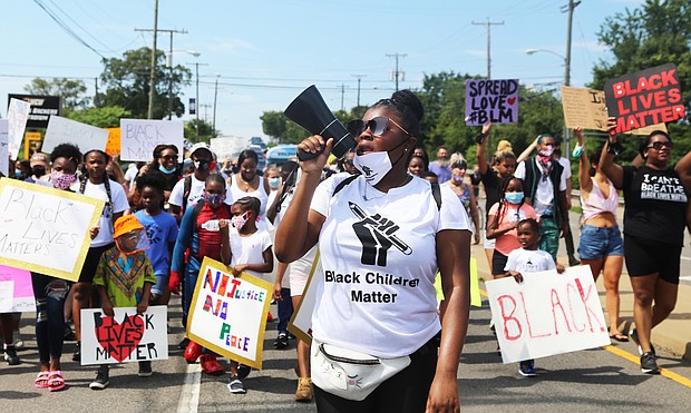 About 100 young people make their way from the Richmond Children’s Museum up Arthur Ashe Boulevard to the Arthur Ashe Jr. Athletic Center as part of the Black Lives Matter Youth & Children’s March last Saturday.