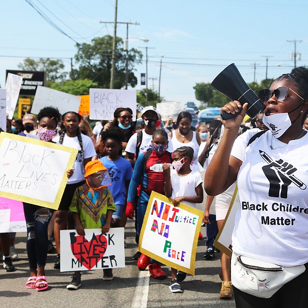 About 100 young people make their way from the Richmond Children’s Museum up Arthur Ashe Boulevard to the Arthur Ashe Jr. Athletic Center as part of the Black Lives Matter Youth & Children’s March last Saturday.