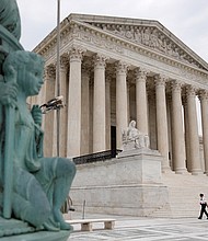 A police officer walks outside the Supreme Court on Capitol Hill in Washington, Monday, July 6, 2020./Credit:	Patrick Semansky/AP