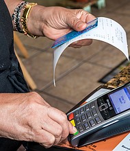 Miami Beach, Tropical Beach Cafe credit card scanner./Credit:	Jeffrey Greenberg/Universal Images Group/Getty Images