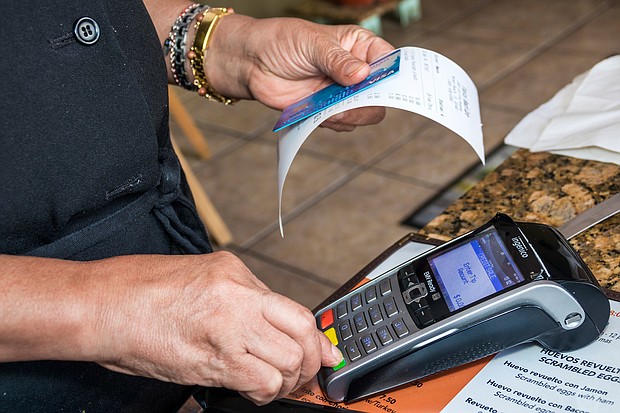 Miami Beach, Tropical Beach Cafe credit card scanner./Credit:	Jeffrey Greenberg/Universal Images Group/Getty Images