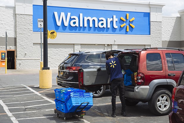 A worker delivers groceries to a customer's vehicle outside a Walmart Inc. store in Amsterdam, New York, U.S., on Friday, May 15, 2020. With the spread of coronavirus slowing in New York, Governor Andrew Cuomo said Monday the state economy is ready to begin reopening, with some regions authorized to do so as soon as this week./Credit:	Angus Mordant/Bloomberg/Getty Images