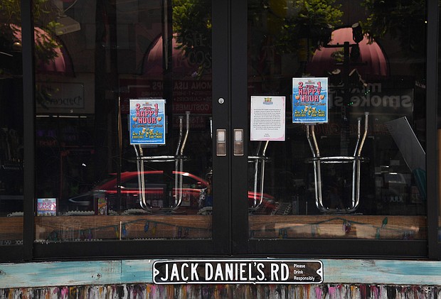 Stools sit upside down on a counter at a closed bar in Hollywood, California./Credit:	Robyn Beck/AFP/Getty Images