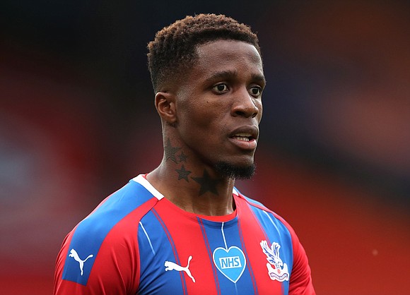 A 12-year-old boy has been arrested in connection with racist threats made to Wilfried Zaha, a star player for the …