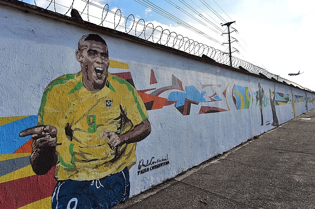 Graffiti depicting Brazilian football star Ronaldo, painted by Brazilian street artist Paulo Consentino in celebration of the FIFA 2014 World Cup./Credit:	Nelson Almeida/afp/getty images