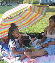 Patricia Robinson, 29, and her daughter, Dejahna Tyler, 7, enjoy the sunshine and each other’s company during a recent outing at Jefferson Park in Church Hill. The family lives in North side.