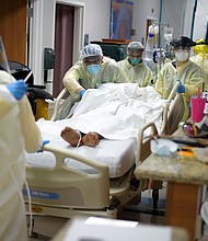 Healthcare workers move a patient in the Covid-19 Unit at United Memorial Medical Center in Houston, Texas, on Thursday, July 2, 2020./Credit:	MARK FELIX/AFP/Getty Images