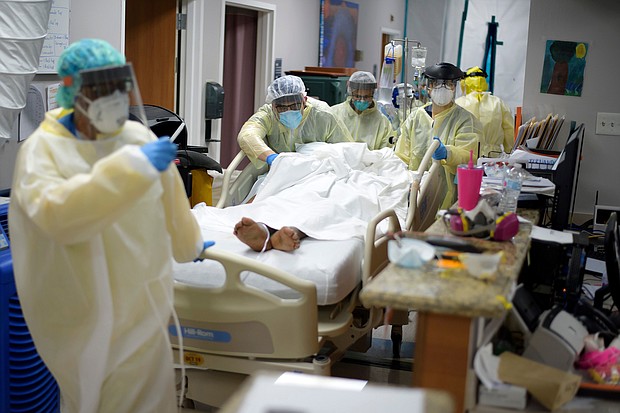Healthcare workers move a patient in the Covid-19 Unit at United Memorial Medical Center in Houston, Texas, on Thursday, July 2, 2020./Credit:	MARK FELIX/AFP/Getty Images