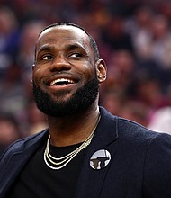 LeBron James trading card sold for $1.8 million at auction./Credit:	Ezra Shaw/Getty Images