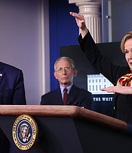 Dr. Birx speaks while flanked by President Donald Trump and Dr. Anthony Fauci during the daily coronavirus task force briefing at the White House on March 31, 2020 in Washington, DC./Credit:	Win McNamee/Getty Images