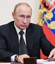 Russia's attempts to influence British politics went unchecked, a new report says. The image shows Russian President Vladimir Putin in a meeting at the Novo-Ogaryovo state residence outside Moscow on May 18, 2020./Credit:	ALEXEY NIKOLSKY/Sputnik/AFP/Getty Images