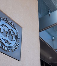 The pandemic recession is hurting women more than men, economists at the International Monetary Fund warned Tuesday. The image shows a sign outside the headquarters of the International Monetary Fund (IMF) in Washington, DC, April 15, 2020./Credit:	Saul Loeb/AFP/Getty Images