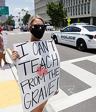 Middle school teacher Brittany Myers takes part in a protest in front of the Hillsborough County Schools District office in Tampa, Florida. Educators have filed a lawsuit seeking to overturn the state's emergency order that forces schools to open for in-person instruction next month./Credit:	Octavio Jones/Getty Images