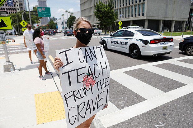 Middle school teacher Brittany Myers takes part in a protest in front of the Hillsborough County Schools District office in Tampa, Florida. Educators have filed a lawsuit seeking to overturn the state's emergency order that forces schools to open for in-person instruction next month./Credit: Octavio Jones/Getty Images