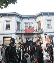 Demonstrators parade past the historic Jackson Ward police-fire station on July 15 on their way to “Reclamation Revival Day 3.” Location: 200 W. Marshall St. They marched to the Richmond Coliseum for a sit-in and speeches before marching and demonstrating about 10:15 p.m. outside the West Clay Street home of City Councilwoman Kim B. Gray.