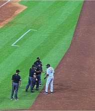 Astros manager Dusty Baker talks with the umpires after the benches were cleared
