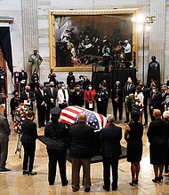 Members of the Congressional Black Caucus, bid farewell at the conclusion of a service Monday for the late Rep. John Lewis, D-Ga., a key figure in the Civil Rights Movement and a 17-term congressman from Georgia, as he lies in state at the U.S. Capitol in Washington.
