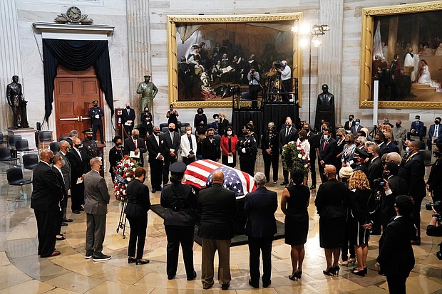 Members of the Congressional Black Caucus, bid farewell at the conclusion of a service Monday for the late Rep. John Lewis, D-Ga., a key figure in the Civil Rights Movement and a 17-term congressman from Georgia, as he lies in state at the U.S. Capitol in Washington.