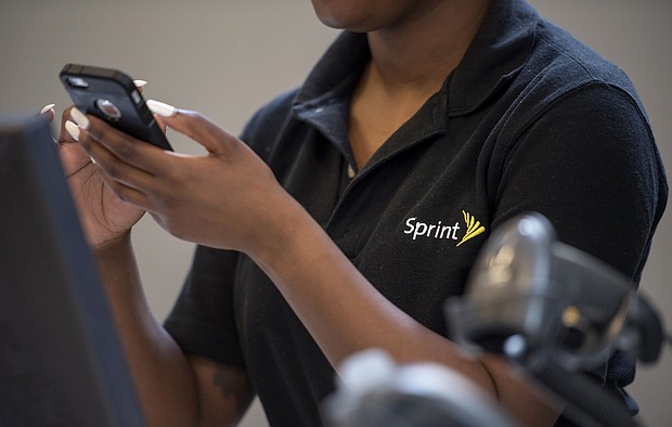 An employee checks an Apple Inc. iPhone for a customer inside a Sprint Corp. store in San Francisco, California on May 5, 2016. T-Mobile US Inc. agreed to acquire Sprint Corp. for $26.5 billion in stock, a wager that the carriers can team up to build a next-generation wireless network and get a jump on industry leaders Verizon Communications Inc. and AT&T Inc./Credit:	David Paul Morris/Bloomberg/Getty Images