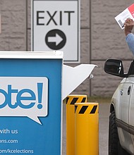 Voters drop off their presidential primary mail-in ballots at a drop box at King County Elections in Renton, Washington on March 10, 2020./Credit:	JASON REDMOND/AFP/Getty Images