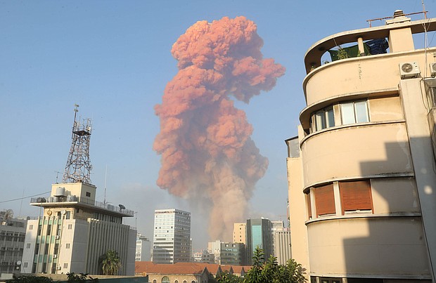 A red cloud hangs over Beirut in the wake of an explosion at the port. The source of the explosion was a major fire at a warehouse for firecrackers near the port in Beirut, the state-run National News Agency reported./Credit:	ANWAR AMRO/AFP/Getty Images