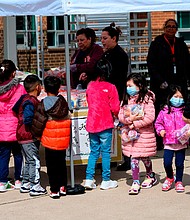 Children, some wearing face masks as a preventive measure, pick up free lunch at Kenmore Middle School in Arlington, Virginia on March 16, 2020, after schools in the area closed due to the coronavirus outbreak./Credit:	Andrew Caballero-Reynolds/AFP/Getty Images