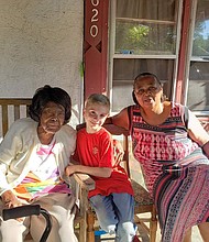 Greyson, center, with two people who received gift cards through his organization, Helping Footprint./Credit:	Courtesy Stevie Winfield