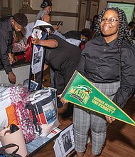 KeAsia Jasper shows off her trunk filled with school supplies, including dorm room necessities, that will accompany her to George Mason University this fall. She was among 14 high school graduates honored with the gifts by the Richmond Redevelopment and Housing Authority on July 28 at its inaugural “Open House in the Village.”