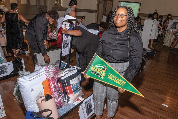 KeAsia Jasper shows off her trunk filled with school supplies, including dorm room necessities, that will accompany her to George Mason University this fall. She was among 14 high school graduates honored with the gifts by the Richmond Redevelopment and Housing Authority on July 28 at its inaugural “Open House in the Village.”