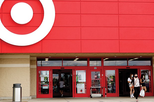 Shoppers wear face masks while leaving a Target store in Niles, Ill. Target announced that it will close its stores Thanksgiving Day as it continues to adjust amid the coronavirus pandemic.