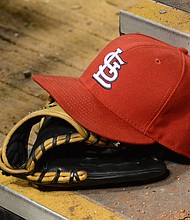 A detailed view of a St. Louis Cardinals baseball hat and glove sitting in the dugout during the game against the Chicago Cubs at Busch Stadium on May 12, 2014 in St Louis, Missouri. The Cubs defeated the Cardinals 17-5./Credit:	Mark Cunningham/Getty Images