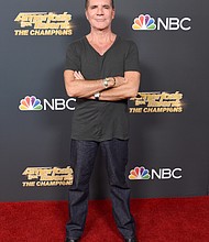 Caption:	Simon Cowell, seen here at the premiere for "America's Got Talent: The Champions," wishes he had read the manual for his new electric bike./Credit:	Gregg DeGuire/Getty Images North America