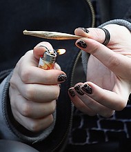 A recreational marijuana smoker indulges in smoking weed on April 14, 2020 in the Bushwick section of the Brooklyn borough of New York City. As some smokers turn to smoking weed to ease their stress during the coronavirus pandemic, some doctors are warning that cannabis can cause airway inflammation that could cause complications should a user become a victim of COVID-19./Credit:	Bruce Bennett/Getty Images