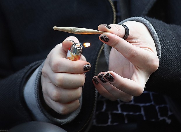 A recreational marijuana smoker indulges in smoking weed on April 14, 2020 in the Bushwick section of the Brooklyn borough of New York City. As some smokers turn to smoking weed to ease their stress during the coronavirus pandemic, some doctors are warning that cannabis can cause airway inflammation that could cause complications should a user become a victim of COVID-19./Credit:	Bruce Bennett/Getty Images