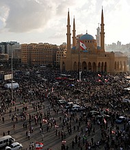 Demonstrators gather at a protest in Beirut on Saturday./Credit:	Thaier Al-Sudani/Reuters