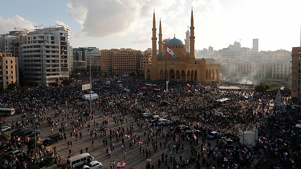 Demonstrators gather at a protest in Beirut on Saturday./Credit:	Thaier Al-Sudani/Reuters