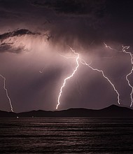Lightning strikes over the Greek Island of Pserimos on June 03, 2015 in Kos, Greece. Migrants are continuing to arrive on the Greek Island of Kos from Turkey who's shoreline lies approximately 5 Km away. Around 30,000 migrants have entered Greece so far in 2015, with the country calling for more help from its European Union counterparts./Credit:	Dan Kitwood/Getty Images