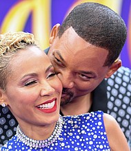 Will Smith and his wife, actress Jada Pinkett Smith, snuggle at a premiere in Hollywood in May 2019./Credit:	Valerie Macon/AFP/Getty Images