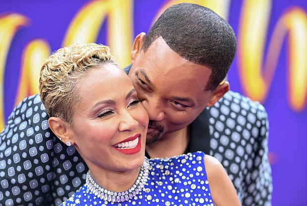 Will Smith and his wife, actress Jada Pinkett Smith, snuggle at a premiere in Hollywood in May 2019./Credit:	Valerie Macon/AFP/Getty Images