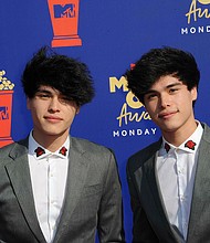 YouTubers Alan (left) and Alex Stokes have been charged with false imprisonment and falsely reporting an emergency, also known as "swatting," during two fake bank robberies in October 2019./Credit:	Hubert Boesl/picture-alliance/dpa/AP Images