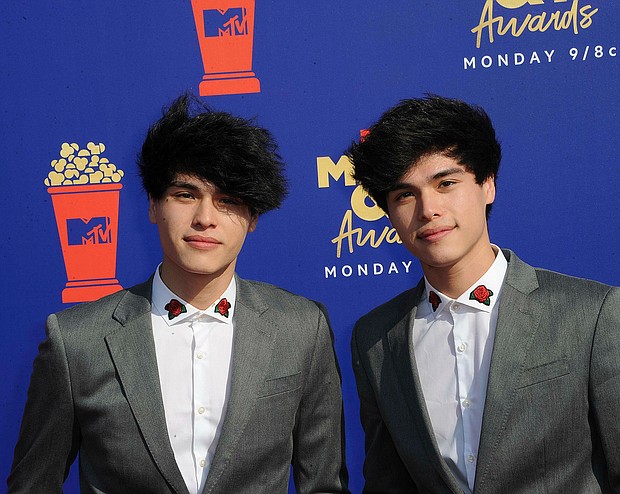 YouTubers Alan (left) and Alex Stokes have been charged with false imprisonment and falsely reporting an emergency, also known as "swatting," during two fake bank robberies in October 2019./Credit:	Hubert Boesl/picture-alliance/dpa/AP Images