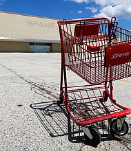 A broken JCPenney shopping cart is seen in an empty parking lot in Niles, Ill., Thursday, June 25, 2020. JCPenney is closing another 13 stores. The department store chain, which filed for bankruptcy last month, is inching toward its target of closing 250 stores about 30% of its network of 846 locations./Credit:	Nam Y. Huh/AP