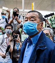 Hong Kong media tycoon and founder of Apple Daily newspaper Jimmy Lai (C) arrives at the West Kowloon Magistrates Court for charges related to last year's protests in Hong Kong on May 18, 2020. - Some of Hong Kong's most prominent pro-democracy activists were charged on May 18 for taking part in last year's huge protests, hours after clashes erupted in the legislature as the city lurches back into a political crisis./Credit:	ANTHONY WALLACE/AFP/AFP via Getty Images
