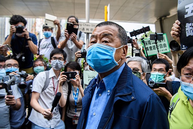 Hong Kong media tycoon and founder of Apple Daily newspaper Jimmy Lai (C) arrives at the West Kowloon Magistrates Court for charges related to last year's protests in Hong Kong on May 18, 2020. - Some of Hong Kong's most prominent pro-democracy activists were charged on May 18 for taking part in last year's huge protests, hours after clashes erupted in the legislature as the city lurches back into a political crisis./Credit:	ANTHONY WALLACE/AFP/AFP via Getty Images