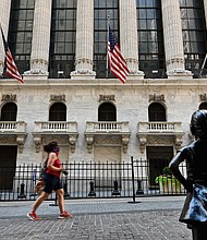 People pass by The New York Stock Exchange (NYSE) on August 3, 2020 at Wall Street in New York City. - Stock markets rose on both sides of the Atlantic August 3, 2020 as hopeful economic data prompted bargain hunting, with some of Asia's equities markets also making solid gains./Credit:	Angela Weiss/AFP/Getty Images